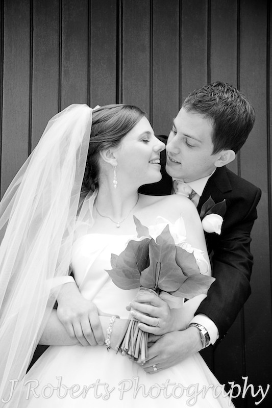 Bride and groom kissing in church doorway - wedding photography sydney